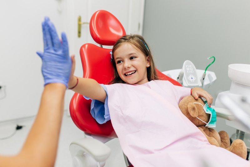 Child high-fiving a dentist