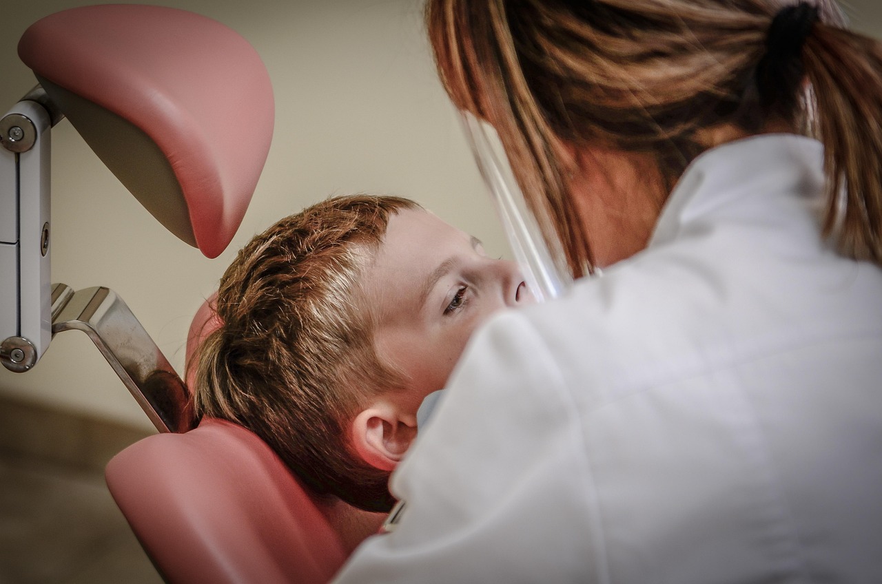 Pediatric dentist interacting with child